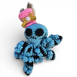 Amigurumi pieuvre décorative originale faite main avec détails dorés et perle.