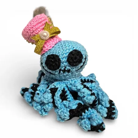 Pieuvre au crochet style vaudou bleu avec chapeau haut-de-forme rose et plumes.